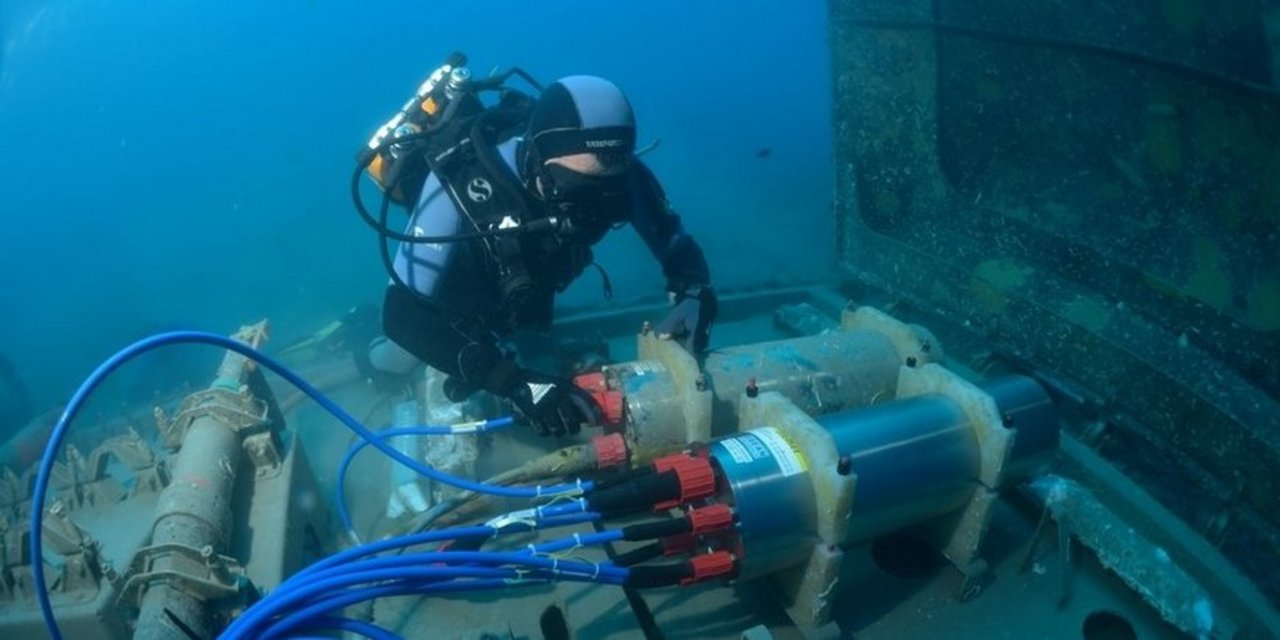 A diver installing a junction box for seafloor cables at the European Multidisciplinary Seafloor and water column Observatory (EMSO) near the Ligurian coast.